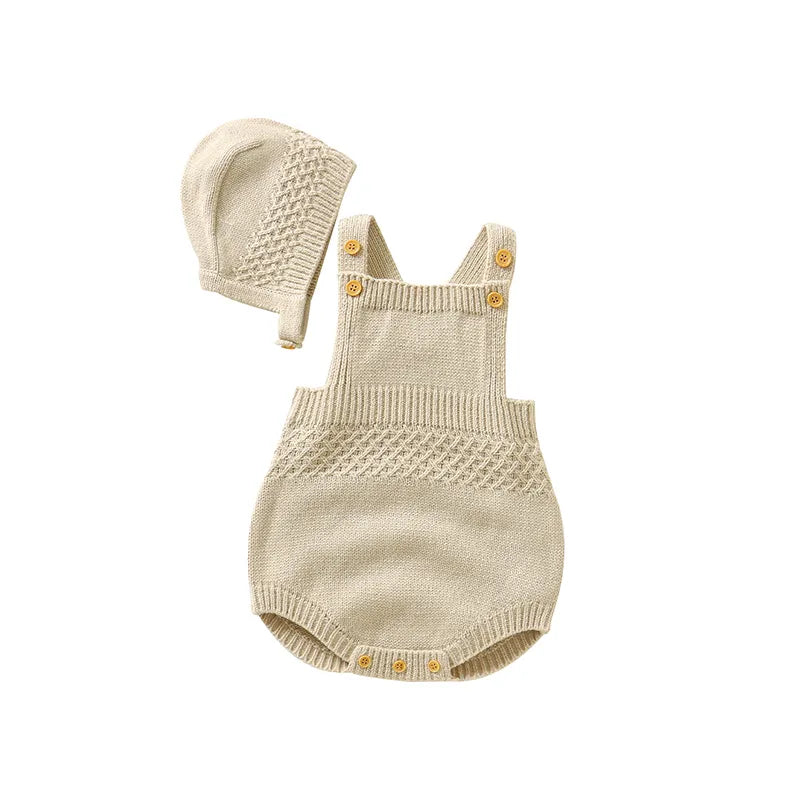 Texture shot of the soft knitted acrylic fabric of a newborn sleeveless onesie and hat