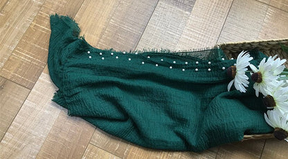 Baby swaddle wrap blanket featuring delicate white beads, essential nursery accessory