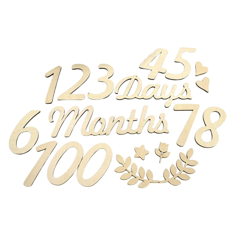 Newborn baby with wooden 'One Month' milestone card, photography prop for infant memory keeping.