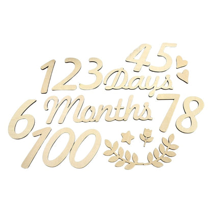 Newborn baby with wooden 'One Month' milestone card, photography prop for infant memory keeping.
