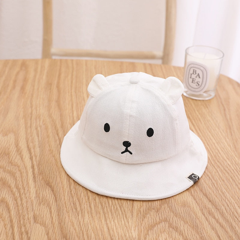Newborn cotton hat with bear ears, designed for comfort and sun defense.