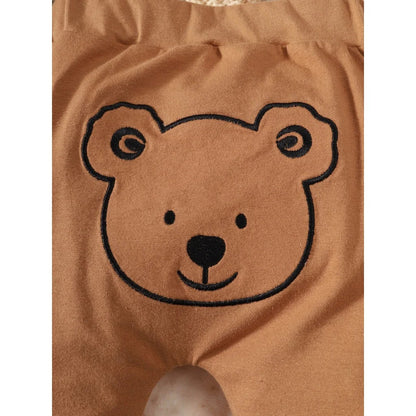 Close-up of the bear print on a newborn boys' pullover top, highlighting the adorable design of this outfit set.