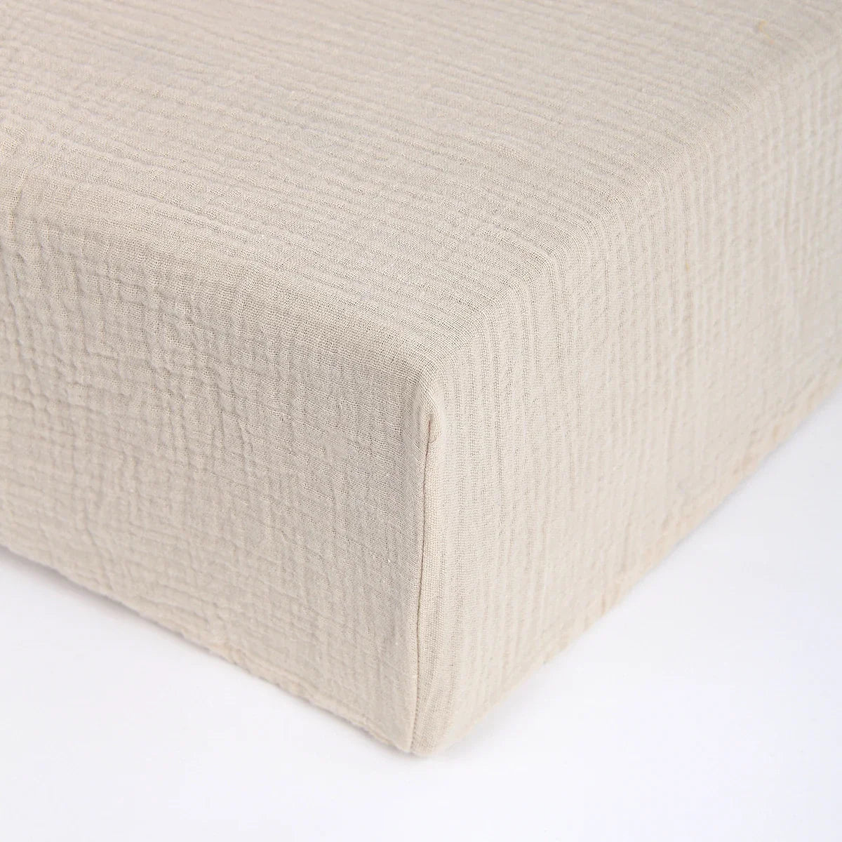 Corner detail of newborn cartoon fitted crib sheet showing elastic for a snug fit on baby crib mattress