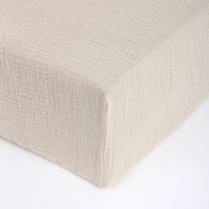 Corner detail of newborn cartoon fitted crib sheet showing elastic for a snug fit on baby crib mattress