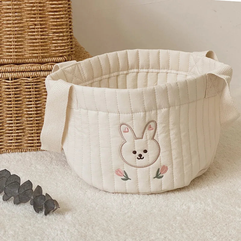 Functional baby storage bag with a charming rabbit print for nursery organization.