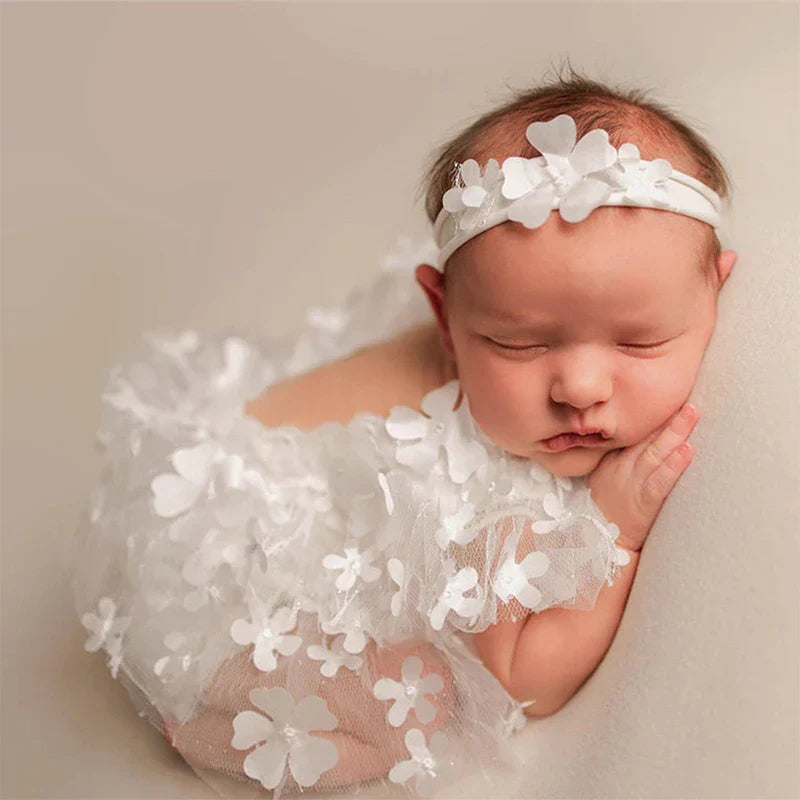 Newborn girl floral romper and matching headband photography set on white background