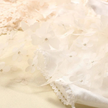 Close-up of the elastic headband with floral bow from the newborn photo set