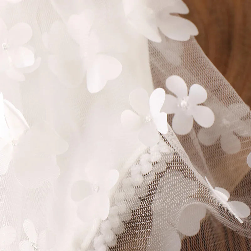 Baby girl's first photo shoot outfit: detailed floral romper and head accessory