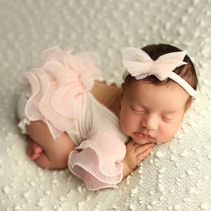 A yellow lace romper & bow headband set, perfect for capturing memorable newborn moments