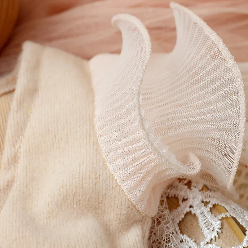 Newborn girl's lavender lace romper with a focus on the bow headband, a stylish baby accessory