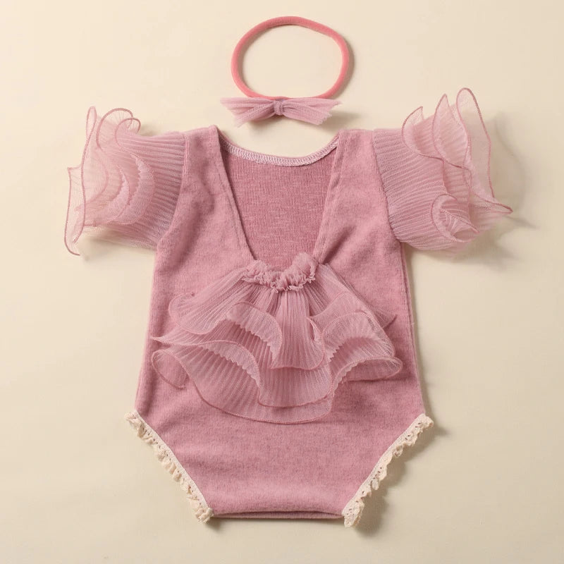 Yellow lace romper on a newborn, with a cute bow headband designed for infant photography