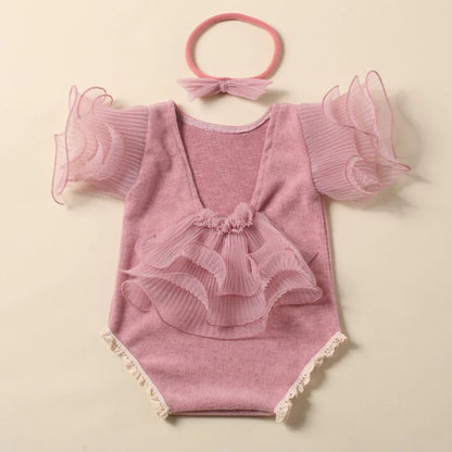 Yellow lace romper on a newborn, with a cute bow headband designed for infant photography
