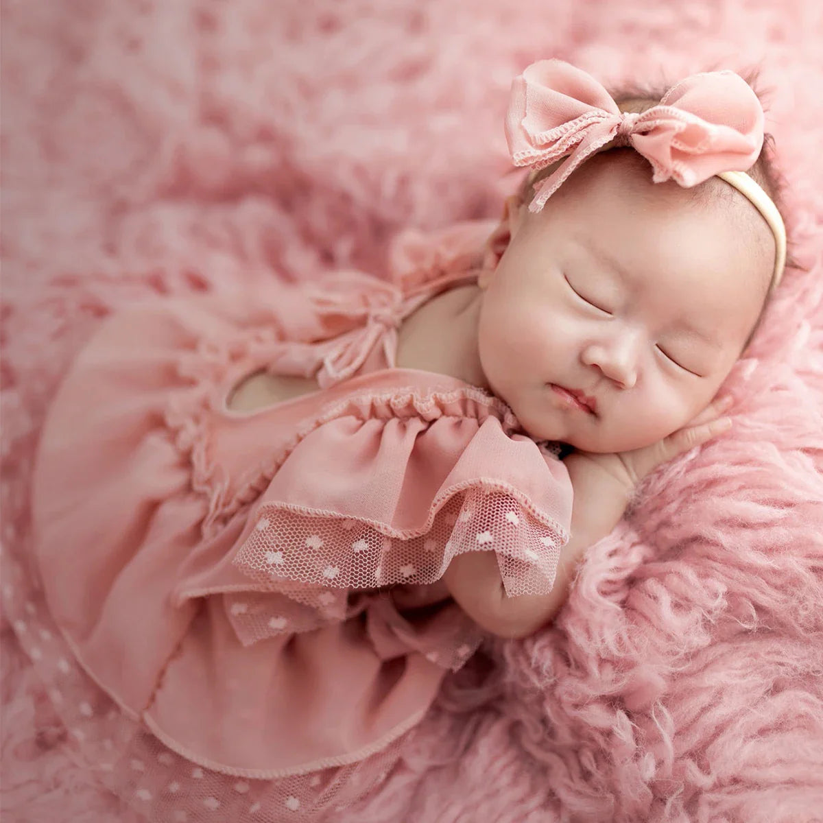 Adorable baby girl light pink romper set with matching headband, ideal infant wear for newborn photography.
