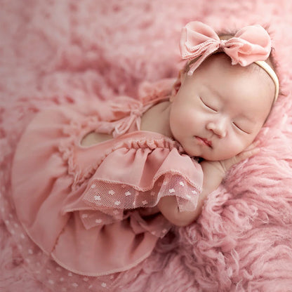 Adorable baby girl light pink romper set with matching headband, ideal infant wear for newborn photography.