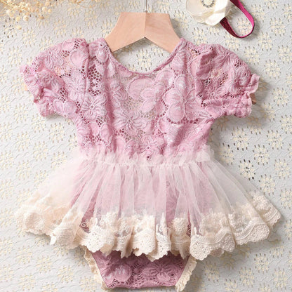 Close-up of dusty pink baby girl lace romper & floral headband, ideal newborn photography outfit