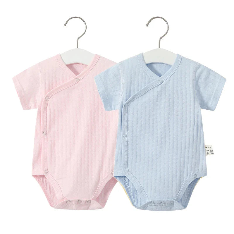 Stylish baby girl's v-neck cotton romper, paired with coordinating bottoms for summer.