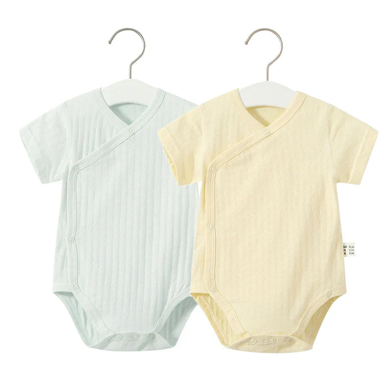Newborn girl's complete summer ensemble: soft cotton romper and diaper cover set.