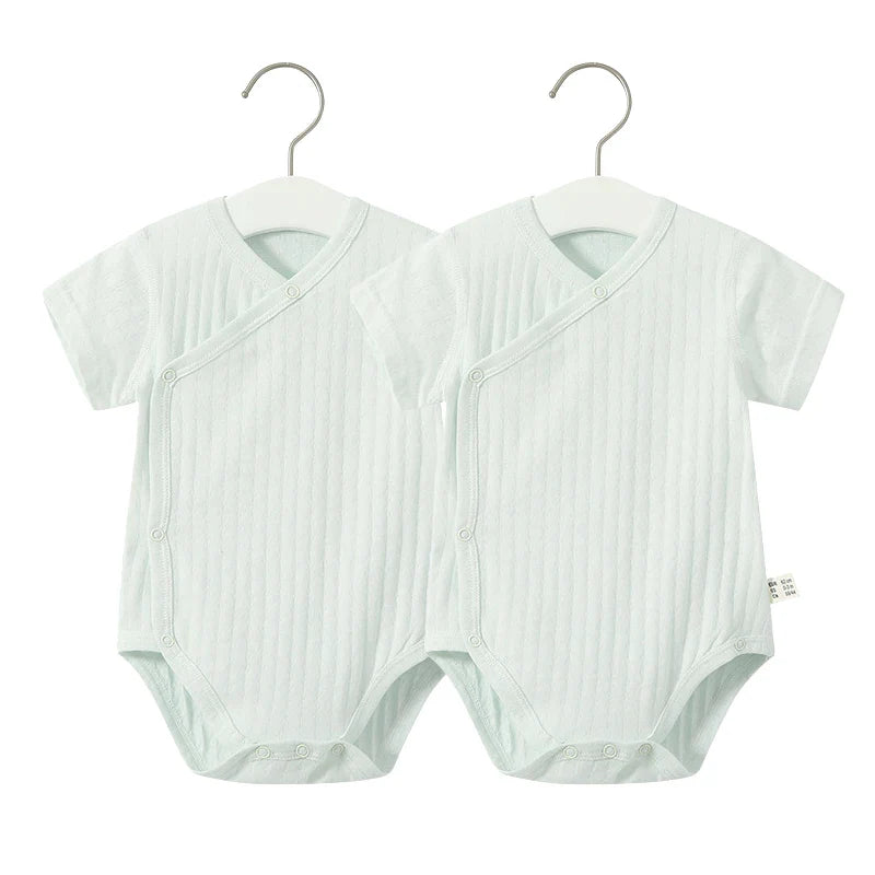 Adorable infant girl's summer fashion, a cotton v-neck romper designed for comfort.