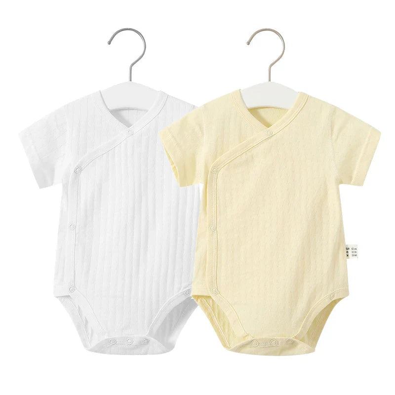 Newborn girl's summer play outfit: practical cotton romper with easy snap closures.