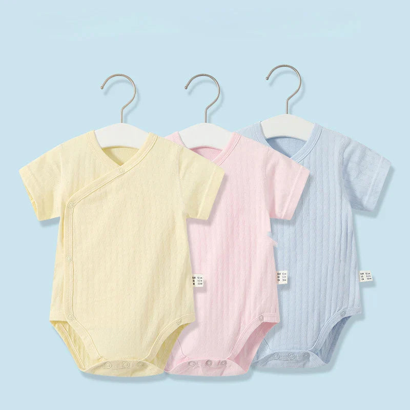 Adorable infant girl's summer outfit: cotton romper with matching headband, soft and stylish.
