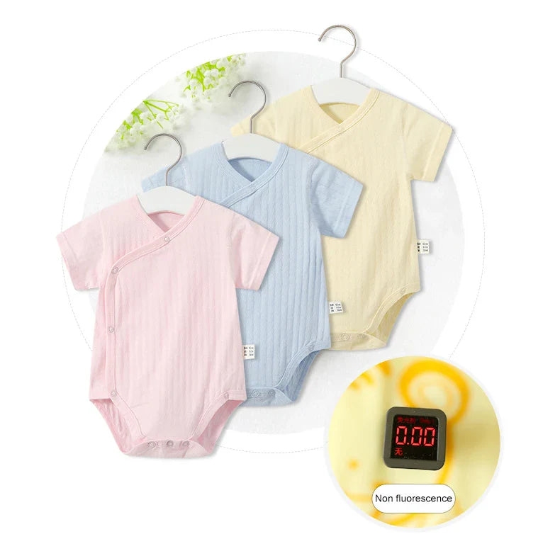 Soft green cotton romper and matching bonnet for newborn girls, suitable for summer outings.