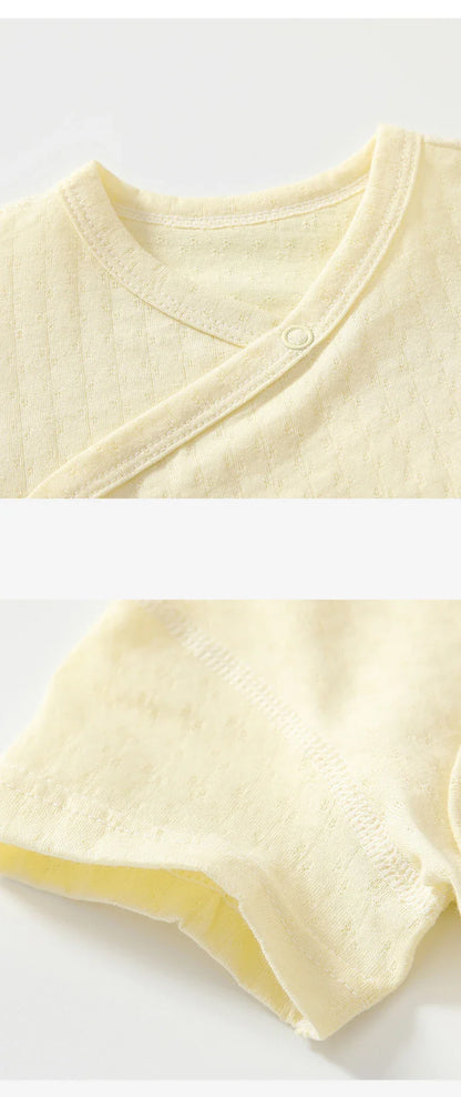 Infant girl's summer wardrobe staple: a durable cotton romper and bloomers set.
