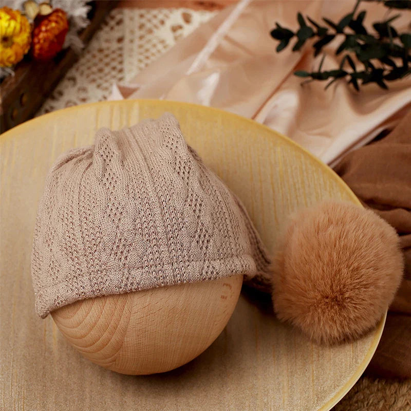Cozy knitted baby jumpsuit and stylish pompom hat, newborn photo ready