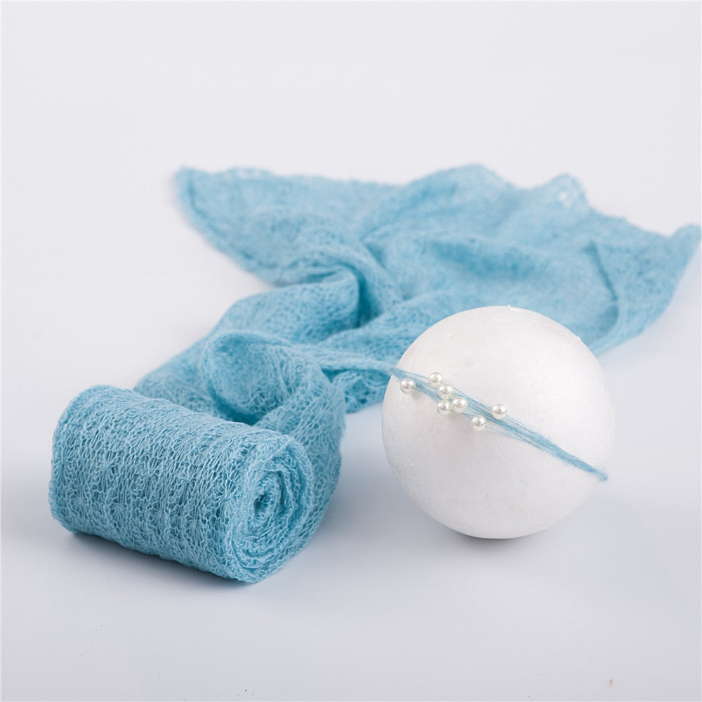 Soft, stretchy mohair newborn swaddle wrap and coordinated headband for infant comfort and cute photos.