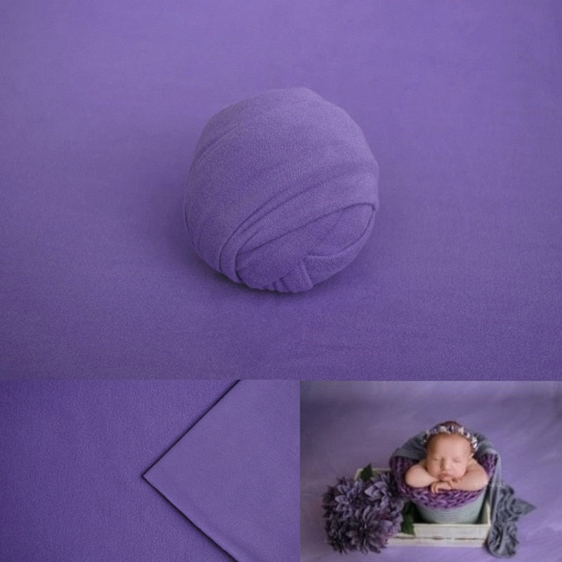 Soft white baby swaddle wrap for photography, paired with a matching textured blanket prop