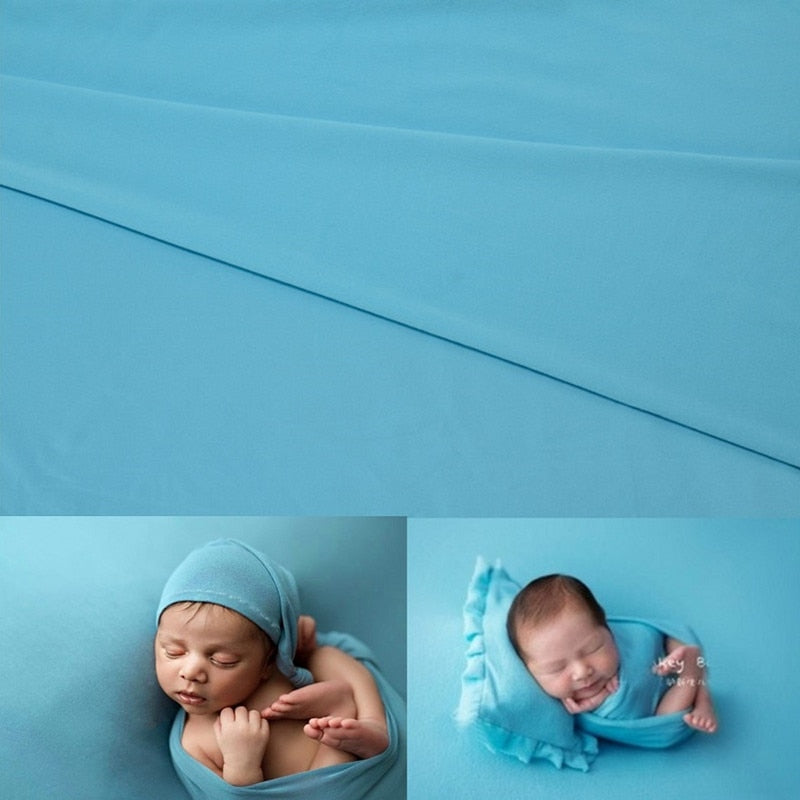 Cute infant photography gear: white swaddle wrap and textured blanket backdrop