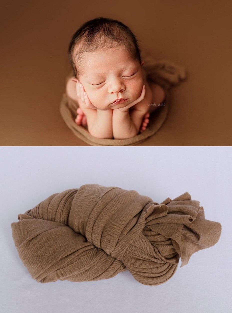 Newborn in a cozy blue cotton swaddle blanket, providing comfort and security.