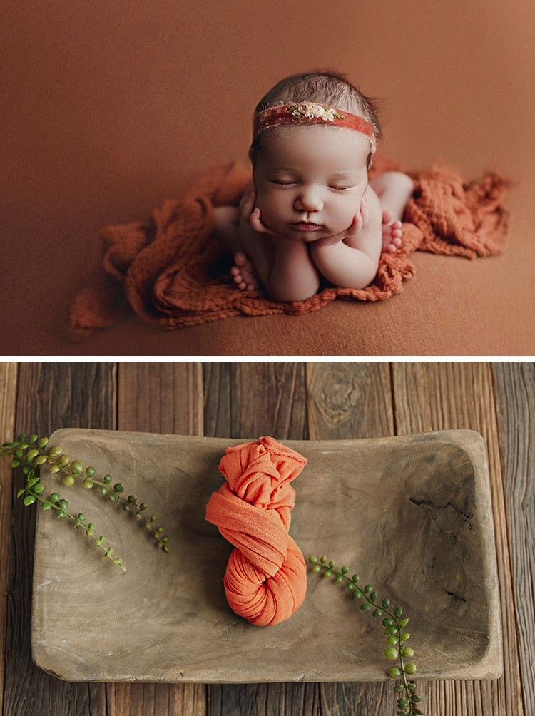 Folded cotton baby swaddle blanket, ready for gifting as a new baby accessory.