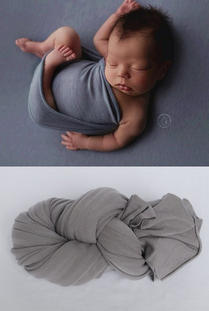 Soft white cotton swaddle blanket, an essential newborn wrap for peaceful sleep.