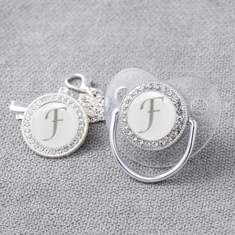 Newborn silicone pacifier with silver bling and clip, a stylish and safe baby item