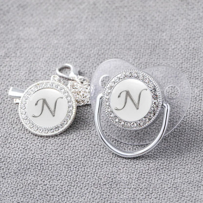 Custom silver pacifier with bling and holder clip, a luxurious baby shower gift idea