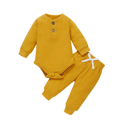 Baby's first outfit: ribbed plaid bodysuit and soft elastic pants, perfect for newborns.