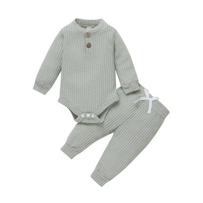 Horizontal view of a newborn unisex ribbed plaid bodysuit and elastic pants set.