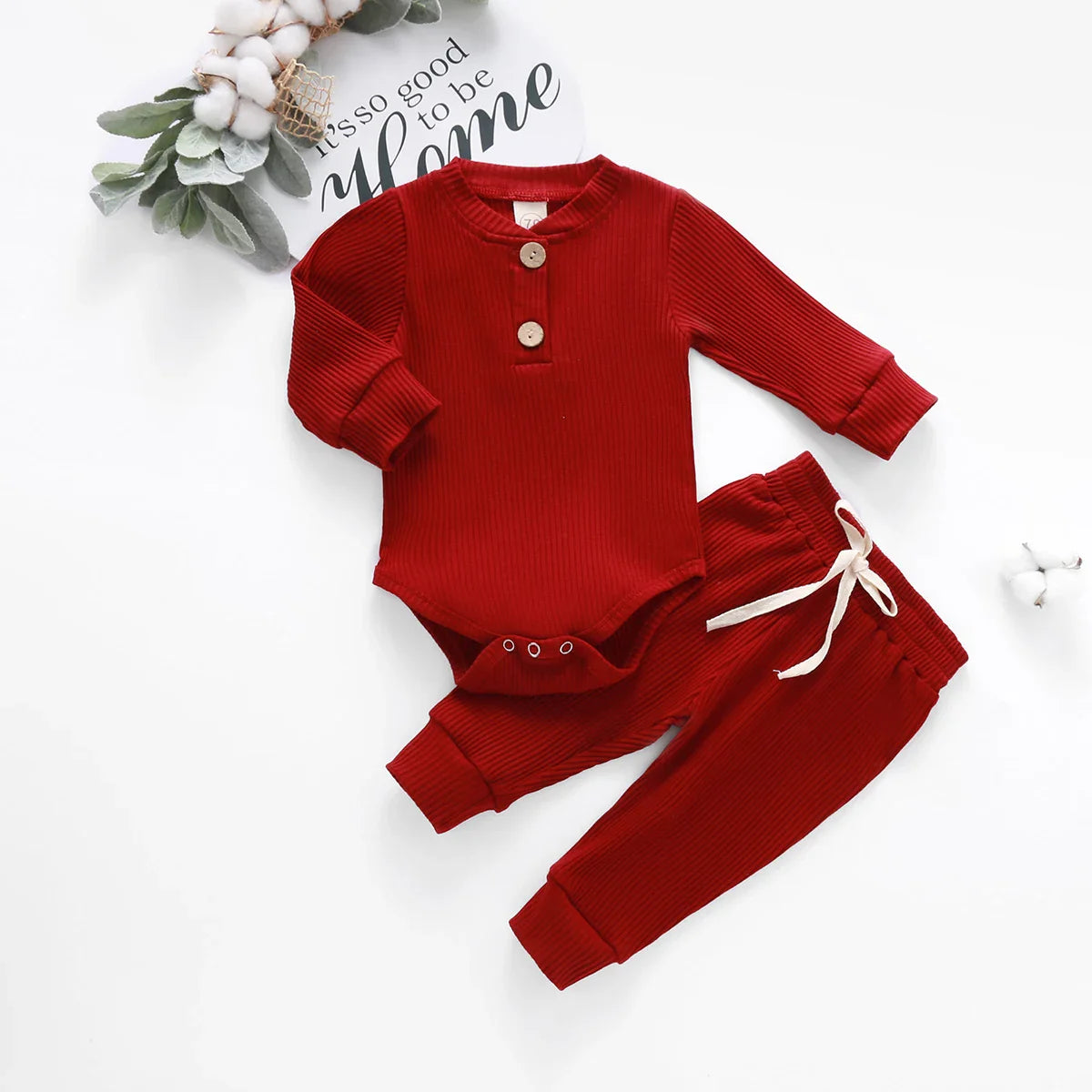 Close-up of ribbed cotton newborn bodysuit featuring a stylish plaid design.