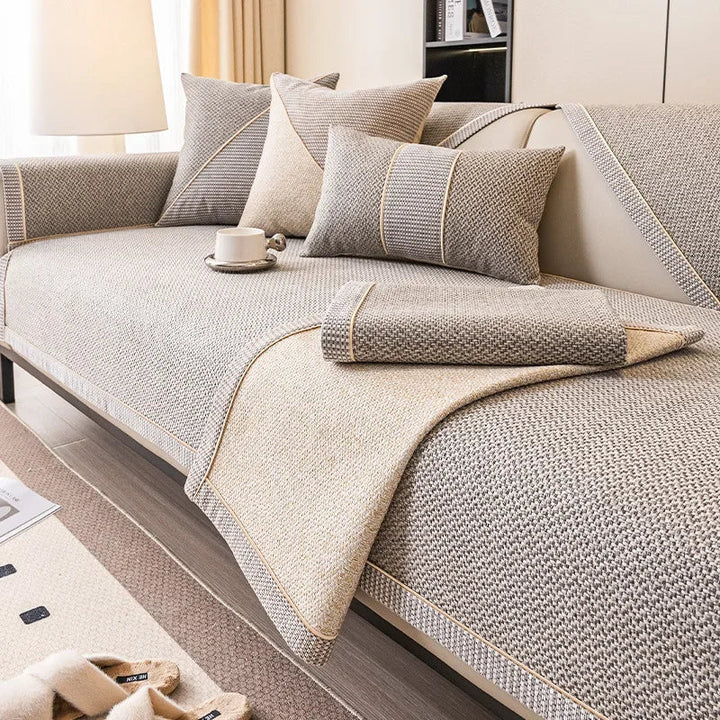 Quilted cotton-linen sofa protector, non-slip design for comfort & durability. All-season use.