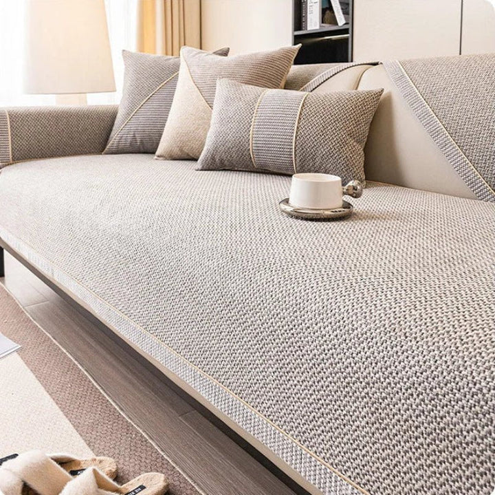 Protect your couch with this non-slip, quilted cotton-linen furniture cover. Spill-proof & pet-safe.