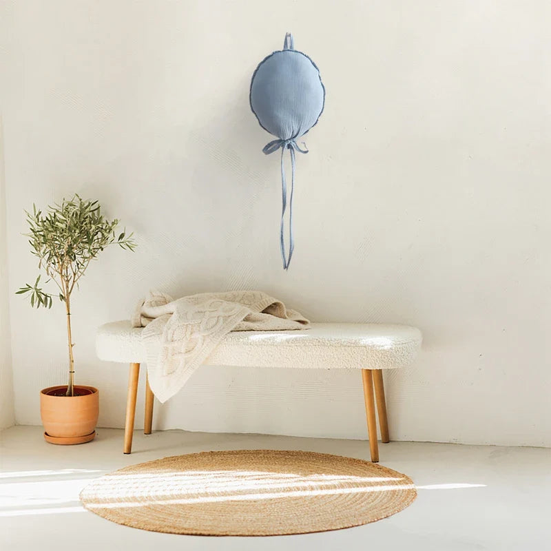 Balloon baby pillow complementing a neutral-toned nursery, adding a touch of Nordic charm