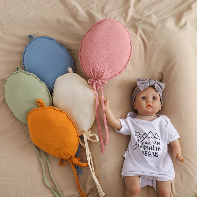 Infant playing near a large balloon pillow, showcasing its use as a fun playroom decor item