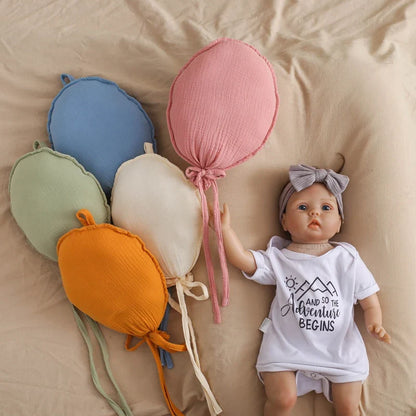 Infant playing near a large balloon pillow, showcasing its use as a fun playroom decor item