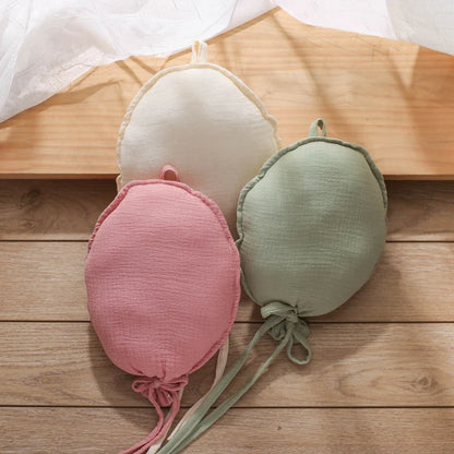 Balloon pillow used as a backdrop for a baby photoshoot, adding a whimsical touch to images