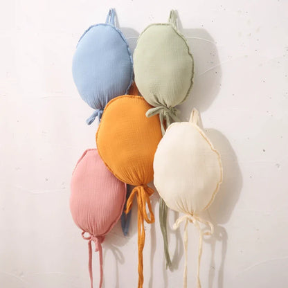 Group of various sized balloon pillows in a kid's bedroom, creating a cozy and inviting space