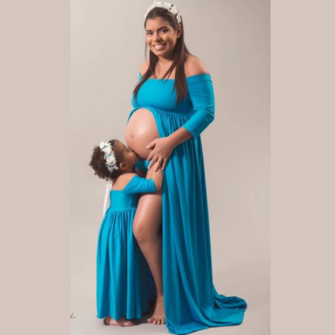 Mom and daughter matching off-shoulder maxi dresses for a cute family photo, ideal for baby clothing events.