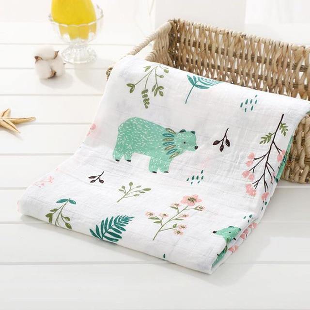 Lifestyle shot of a parent gently swaddling a baby in a soft muslin blanket for peaceful sleep