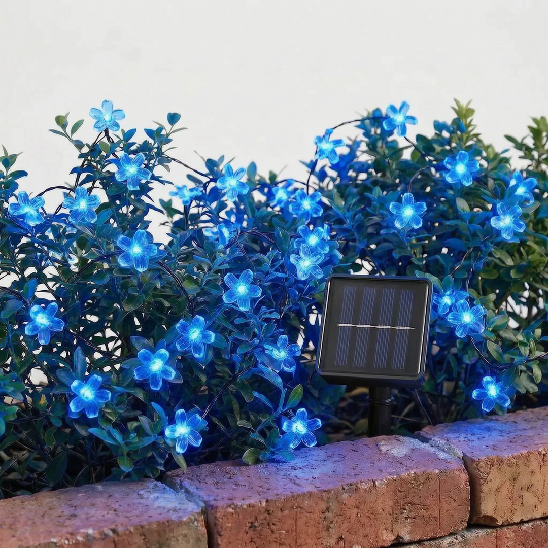 Decorative solar blossom string lights enhancing a backyard party scene. Beautiful ambient lighting.