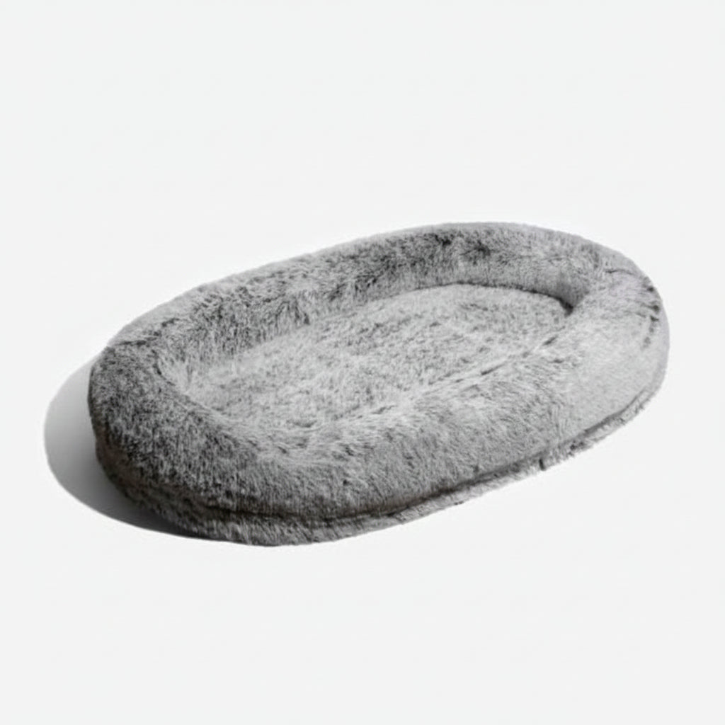 Brown oversized anti-anxiety calming bed, perfect for human & pet lounging. Features a soft, washable faux fur cover.