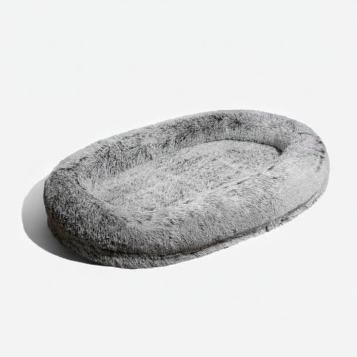 Brown oversized anti-anxiety calming bed, perfect for human & pet lounging. Features a soft, washable faux fur cover.